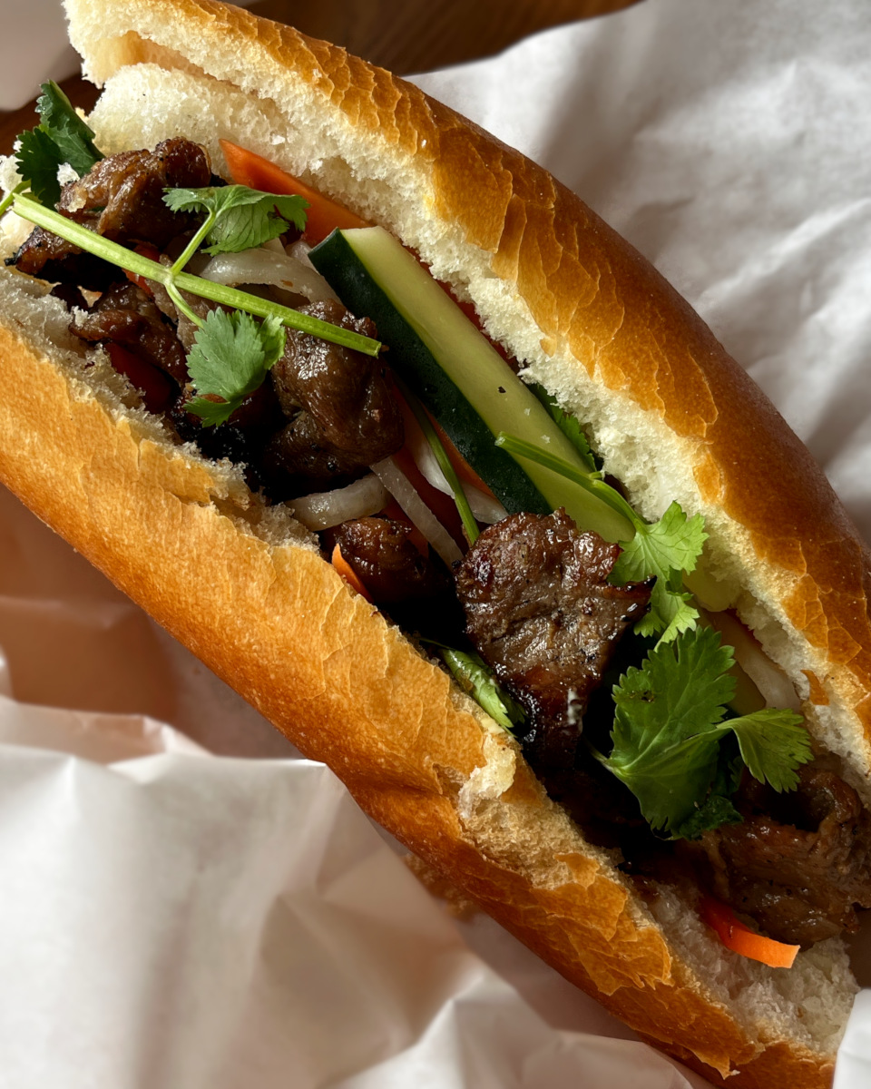 grilled pork banh mi sand wich with pickled vegetables and cilantro