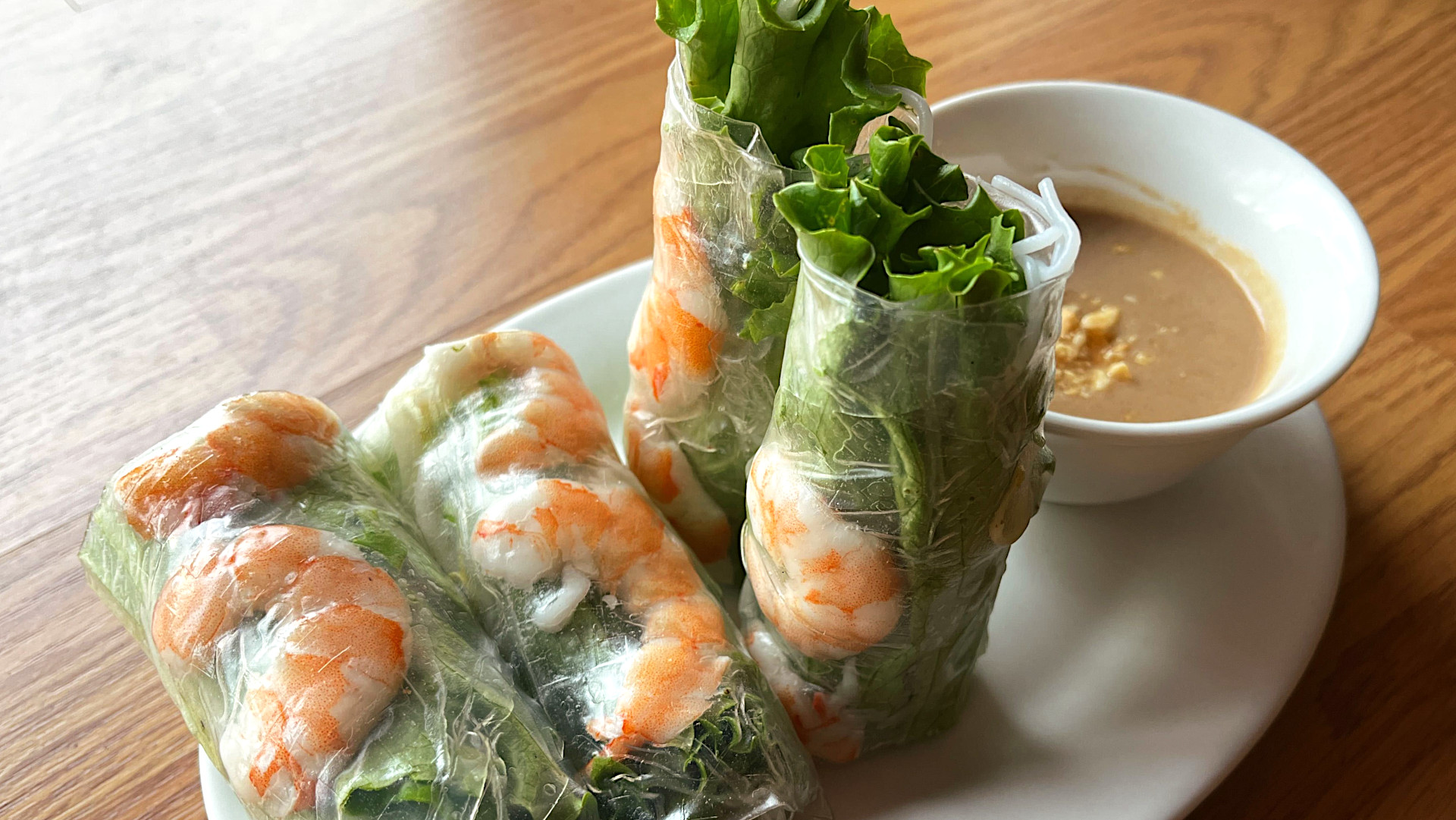 Fresh Vietnamese shrimp spring rolls with lettuce, rice noodles, and peanut dipping sauce