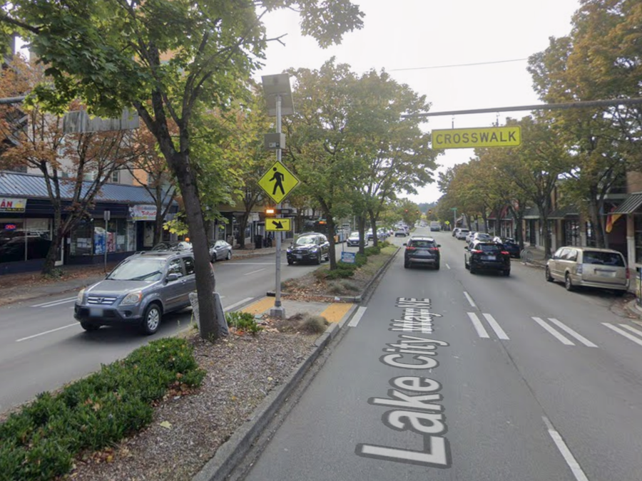 Marked crosswalk across Lake City Way NE with pedestrian sign